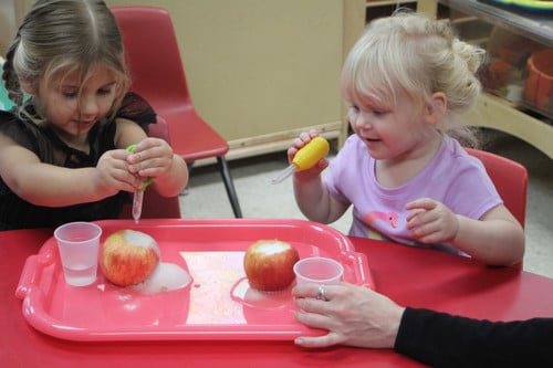 children experimenting with apples