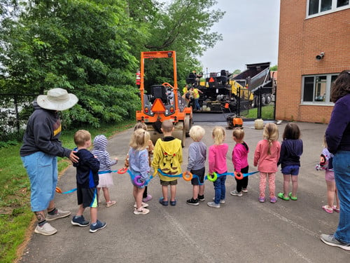 children watching the construction trucks