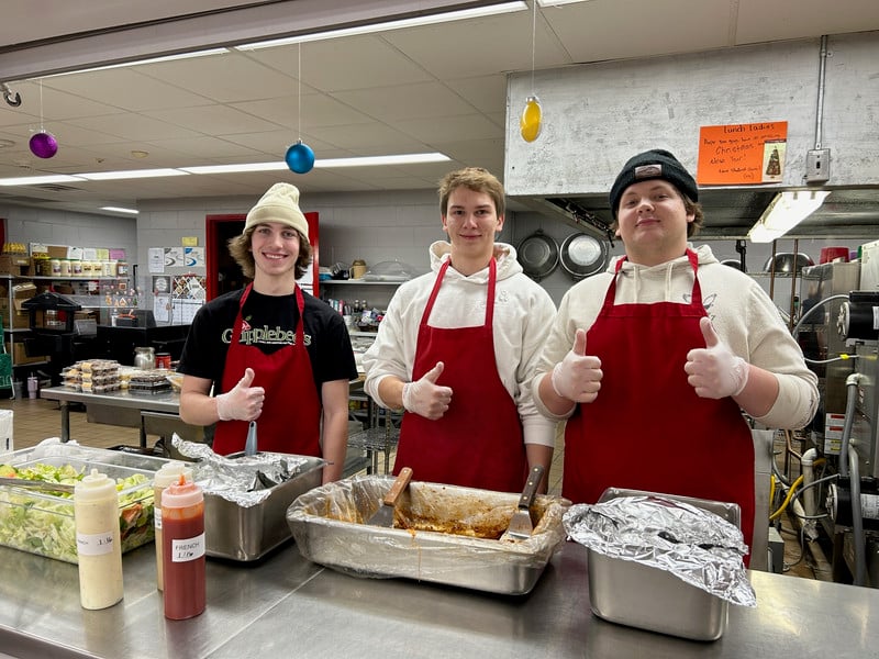 Seniors serving lasagna