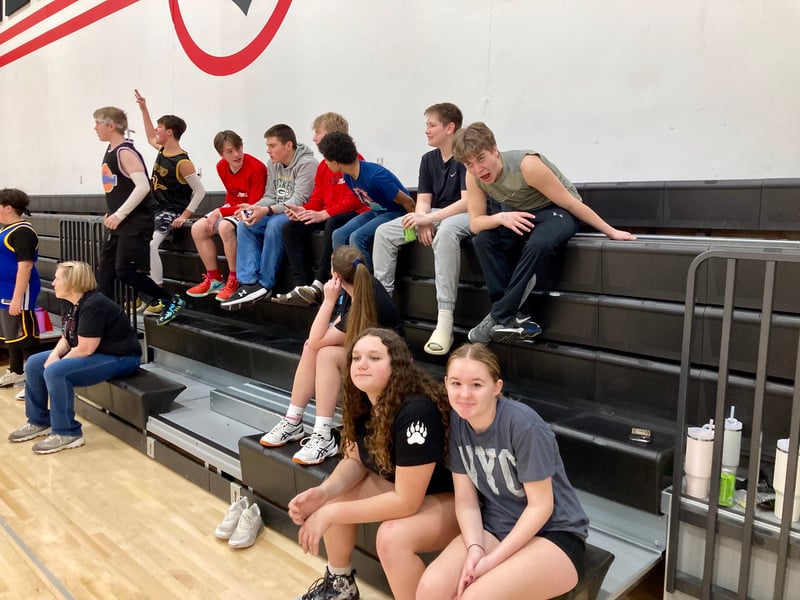 students sitting on bleachers