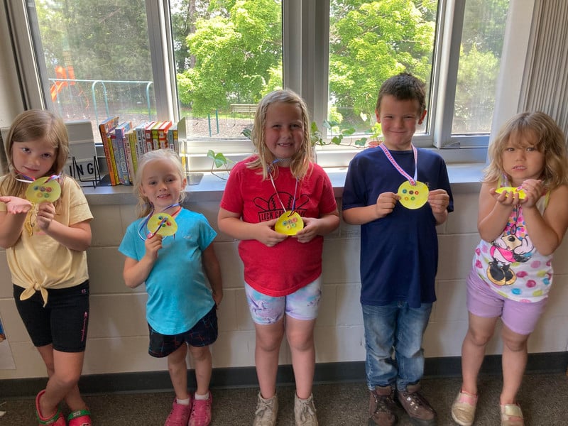 students with homemade medals