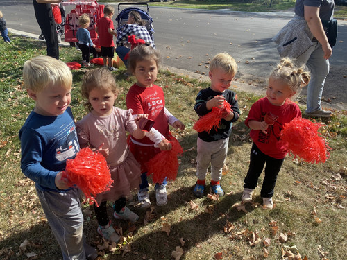 children cheering at a parade